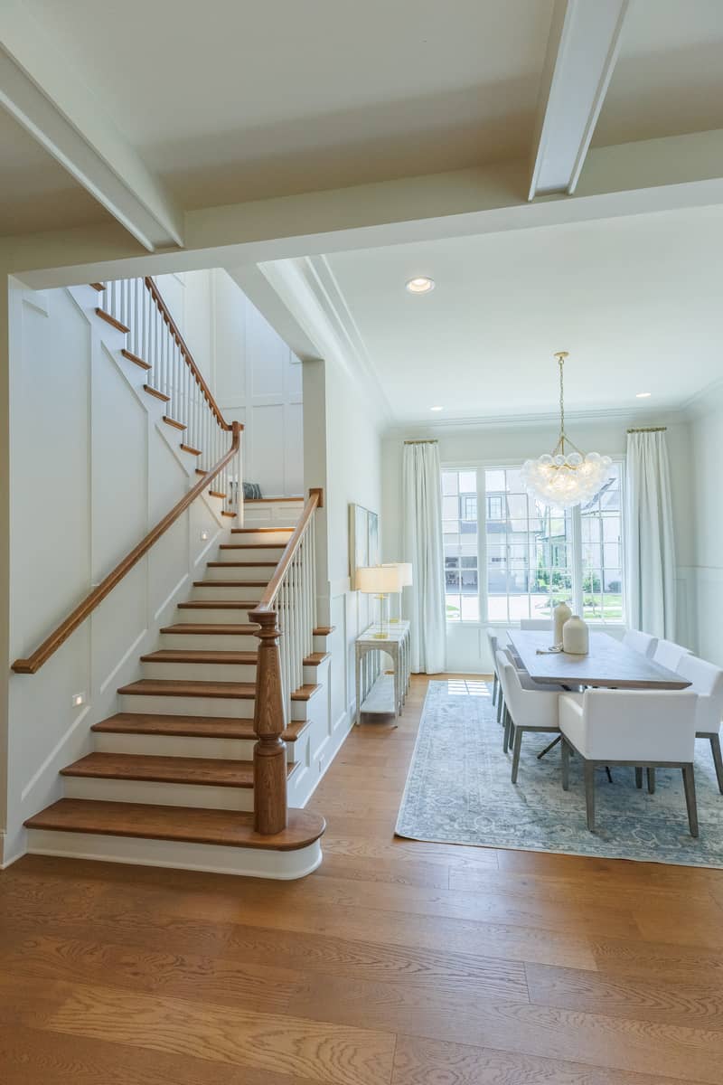 Elegant dining room and staircase in a modern home with natural light